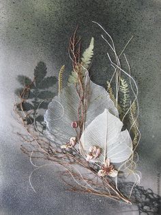 an arrangement of leaves and twigs on a table