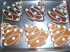 six decorated cookies sitting on top of a pan