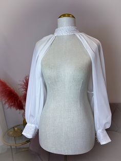 a mannequin with a white blouse on it