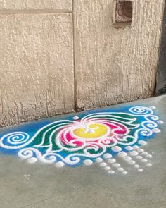 the sidewalk is painted with colorful designs on it