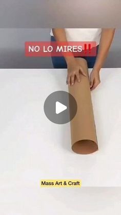 a person sitting on top of a roll of paper next to a sign that says no lo mirres