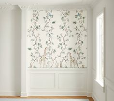 an empty room with white walls and floral wallpaper