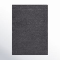 a dark gray rug on a white background