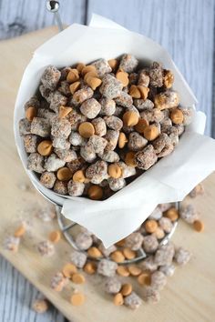 a white bowl filled with dog treats on top of a wooden table