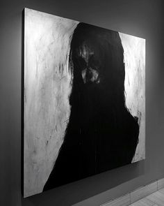 a black and white photo of a woman's face on a wall in an art gallery