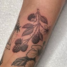 a close up of a person's leg with a tattoo on it and flowers