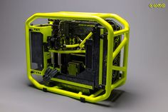 a yellow and black computer case sitting on top of a gray surface with wires running through it