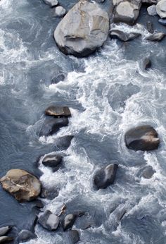 rocks in the water next to large boulders