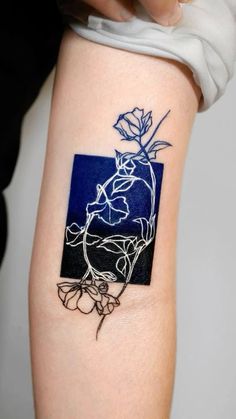 a tattoo on the arm of a woman with a flower in it's center