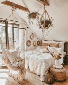 a bedroom with a hammock hanging from the ceiling and pillows on the bed