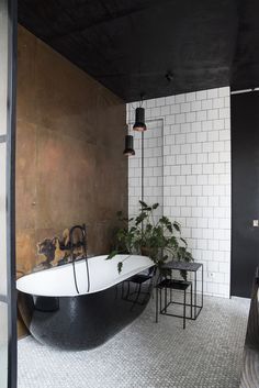 a bathroom with a large bathtub next to a sink