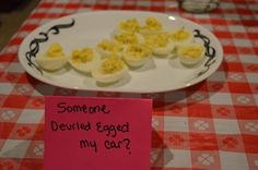 some deviled eggs are on a plate with a note that says someone deviled egg my car?