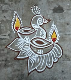 an artistic painting on the ground with candles in it's hands and two birds