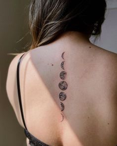 the back of a woman's shoulder with phases on it