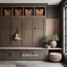 a room with wooden cabinets and baskets on the wall