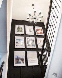 an image of a staircase with pictures on the wall