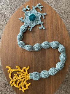 two crocheted bracelets sitting on top of a wooden table