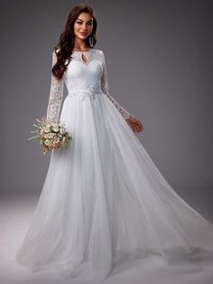 a woman in a white wedding dress with long sleeves and lace on the top is holding a bouquet