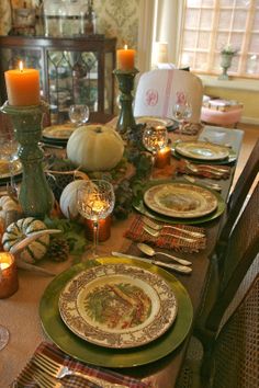 a dining room table set for thanksgiving dinner