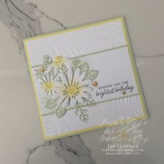 a close up of a greeting card on a marble surface with the words, wishing you the brightest birthday