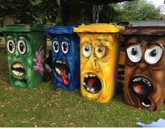 four trash cans with faces painted on them