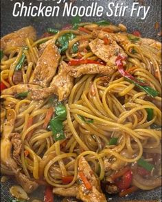 chicken noodle stir fry in a wok