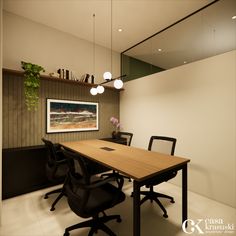 a wooden table sitting in the middle of a room next to two black chairs and a potted plant