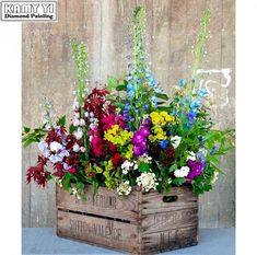 flowers in wooden crates are arranged on the table and placed next to eachother