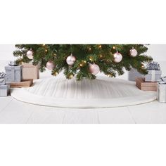 a christmas tree with presents under it on the floor in front of a white background