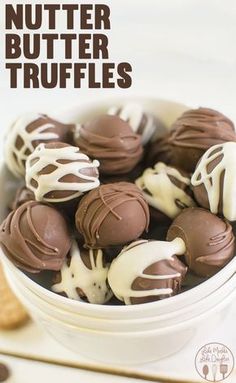 a bowl filled with chocolate covered truffles on top of a table