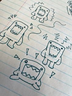 an open notebook with doodles and monsters drawn on the pages, including one monster