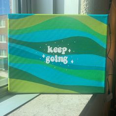 a painting that says keep going on the side of a window