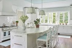 a kitchen with white cabinets and an island