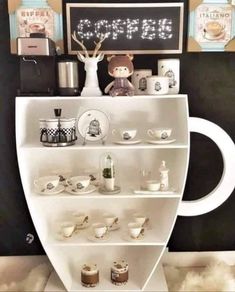 a white shelf filled with cups and saucers