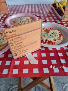 a table topped with pizza on top of a red and white checkered table cloth