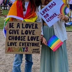 two women standing next to each other holding up signs that say, be a lover give love choose love love love everyone always