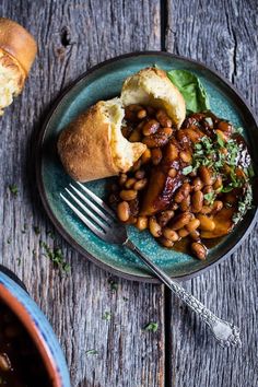 a blue plate topped with beans and bread