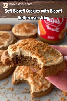 soft biscuit cookies with biscott buttercream icing are being held up