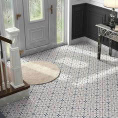 an entryway with white and blue tile on the floor next to a door way