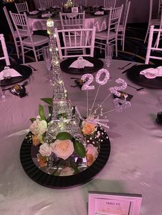 the eiffel tower centerpiece is decorated with flowers