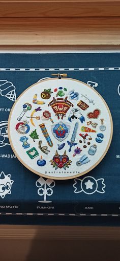 the embroidery on the table is decorated with many different things in it's center