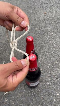 someone tying a string around two bottles