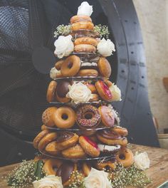 a tower made out of doughnuts and roses