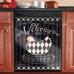 a welcome sign is hanging on the kitchen cabinets