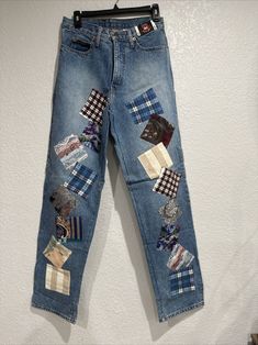 a pair of blue jeans with patches on them