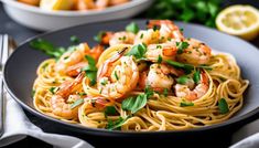 a plate of pasta with shrimp and parsley