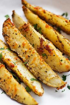 grilled potato wedges on a white plate garnished with parmesan