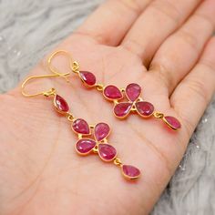 These handmade Indian ruby earrings are crafted with natural ruby gemstones, the perfect July birthstone. Designed as minimalist dangle earrings, they feature a mix of gold earrings and silver earrings for a unique look. The vibrant red earrings highlight the beauty of ruby jewelry and are perfect as gemstone earrings or birthstone earrings. Elegant yet dainty, these earrings are ideal for adding a touch of sophistication to any outfit. Check out more at https://www.etsy.com/uk/shop/MysticPearls Gold Ruby Earrings, Red Ruby Earrings, Gold Beauty, Outfit Check, Silver Earrings Handmade, Birthstone Earrings, Indian Wedding Jewelry, Indian Earrings, Earrings Elegant