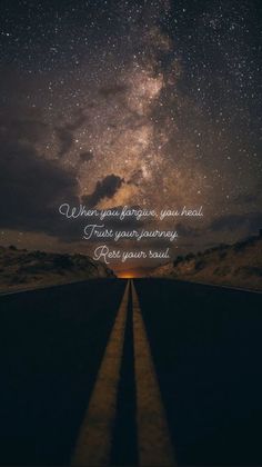 an empty road with the stars in the sky above it and a quote written on top