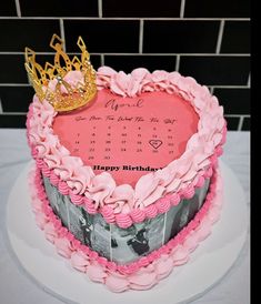 a heart shaped birthday cake with a crown on top